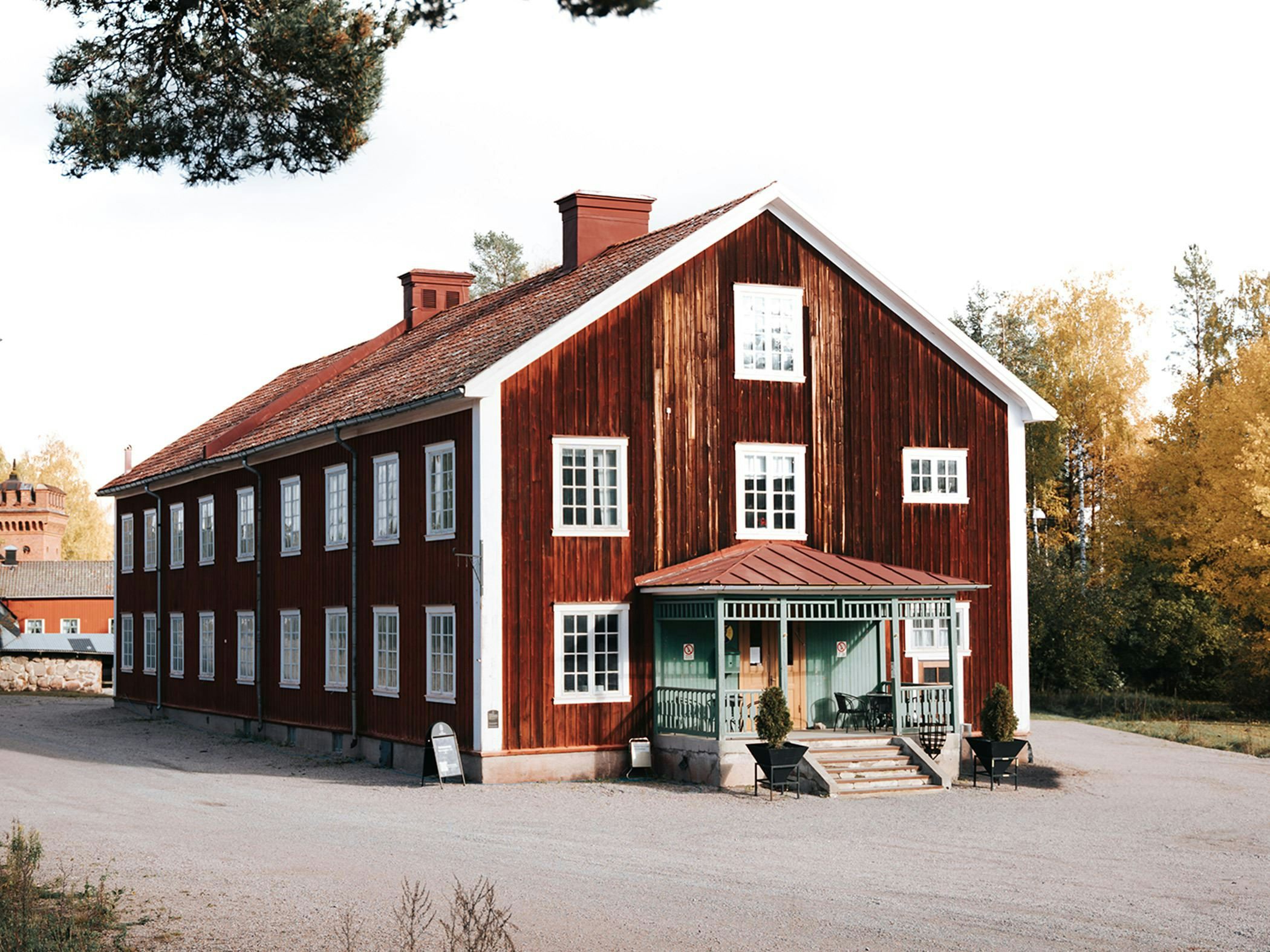 Historic charm with a rustic red facade and green entrance hall.