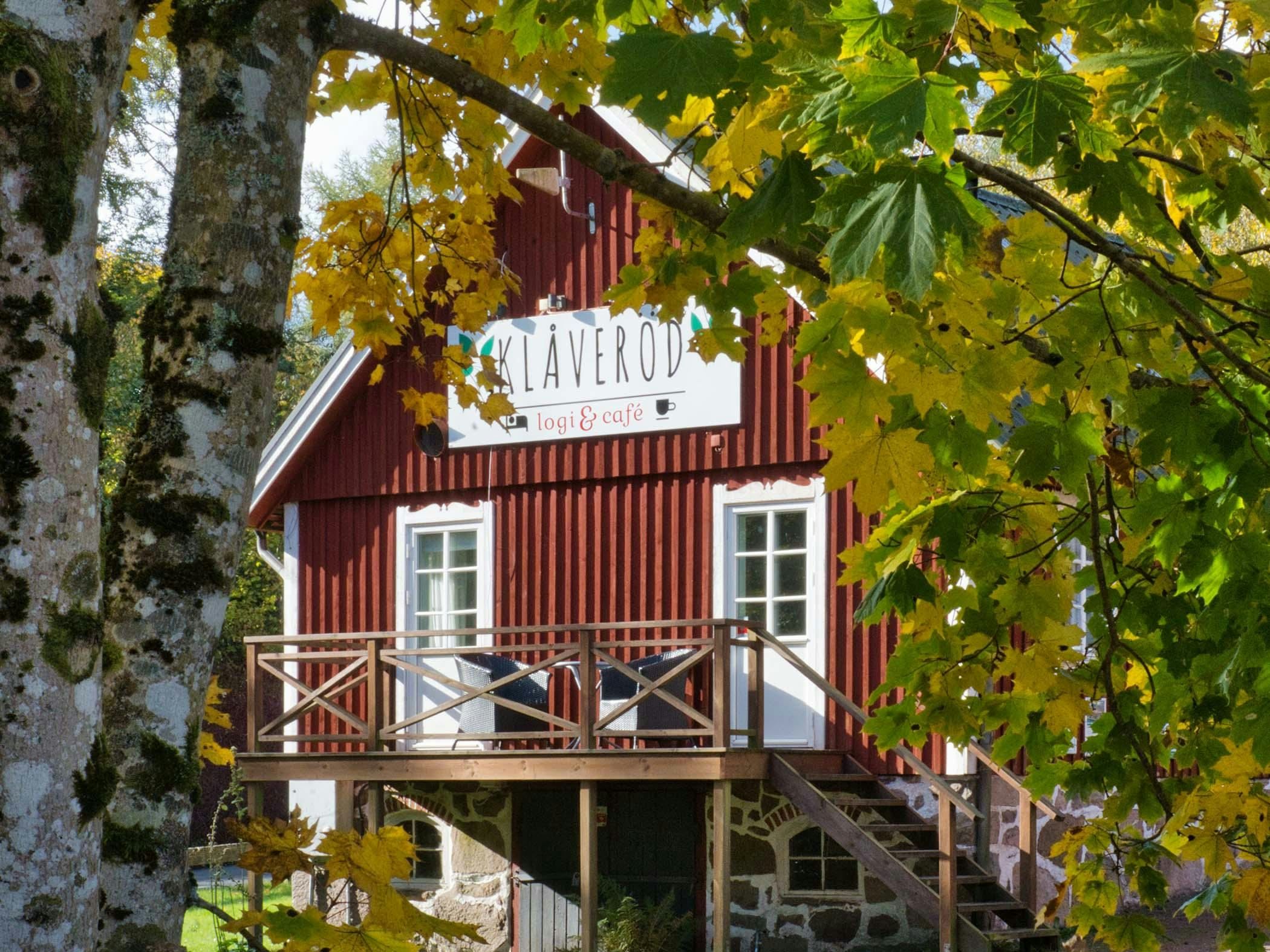 Red wooden building with the sign 
