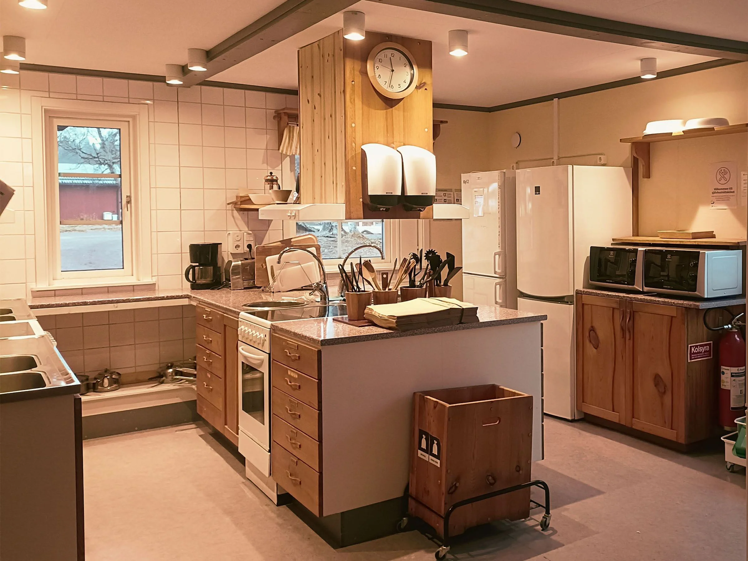 Kitchen with an island and a wooden ceiling.